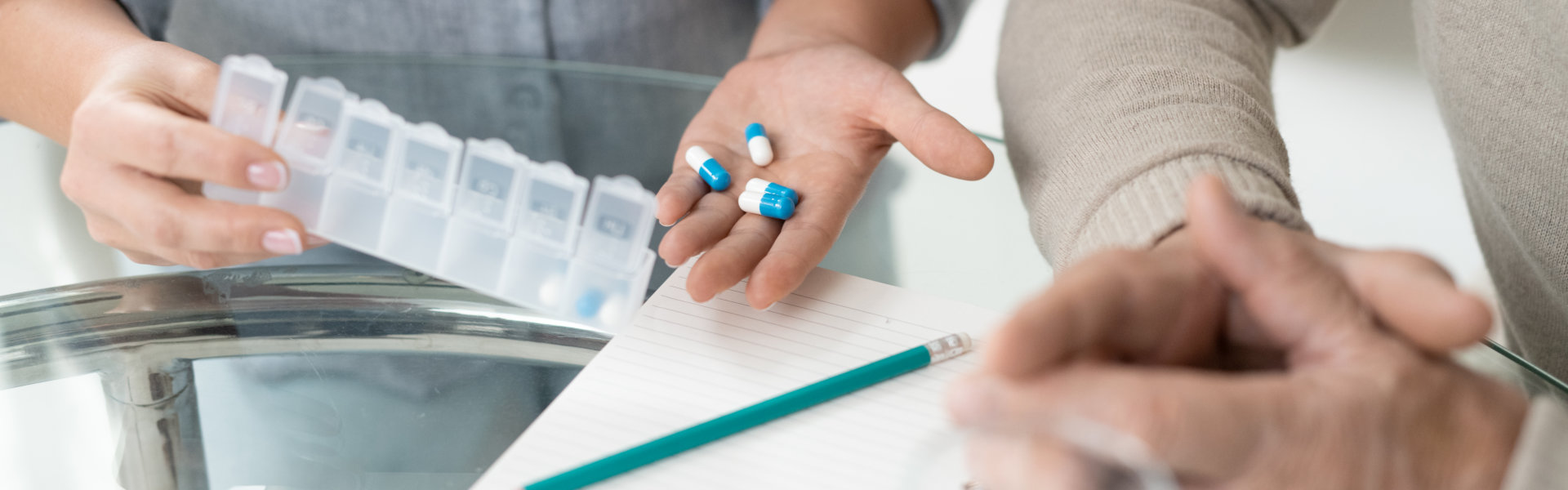 hands of a woman holding pills